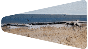 Damaged and peeling sealant at the base of an exterior wall joint.
